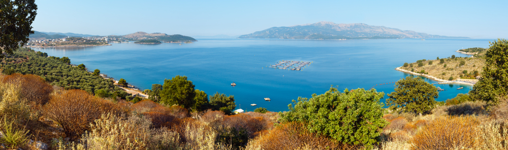 Summer morning coast and Ksamil town on shore